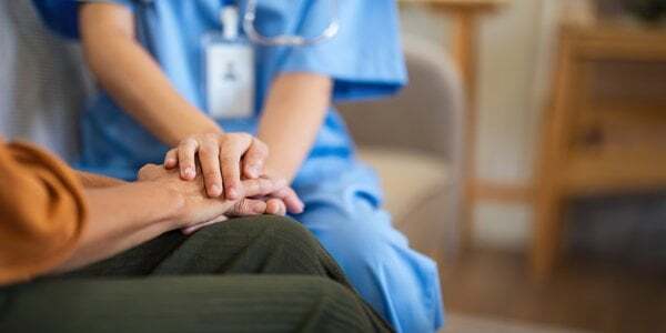 assisted-living-nurse-holding-patient-hand-care-2